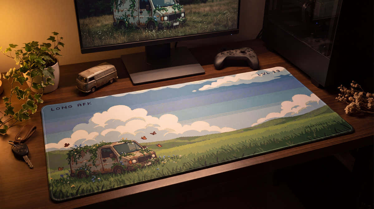 Long AFK pixel art desk mat on a desk at night