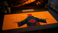 Pain anime desk mat in a warm orange PC setup